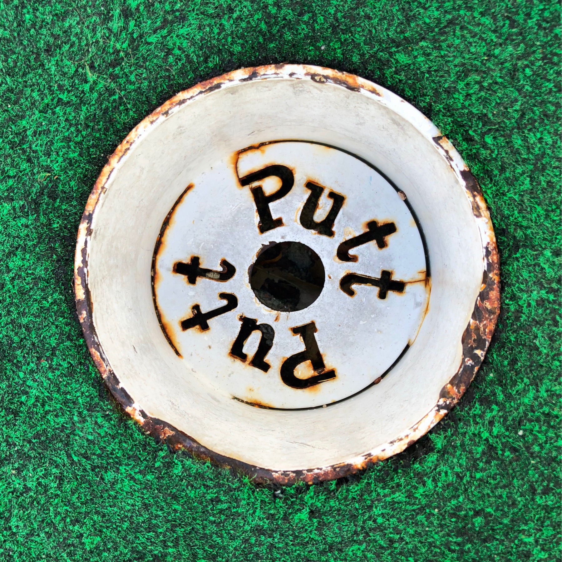 bottom of a mini golf hole 