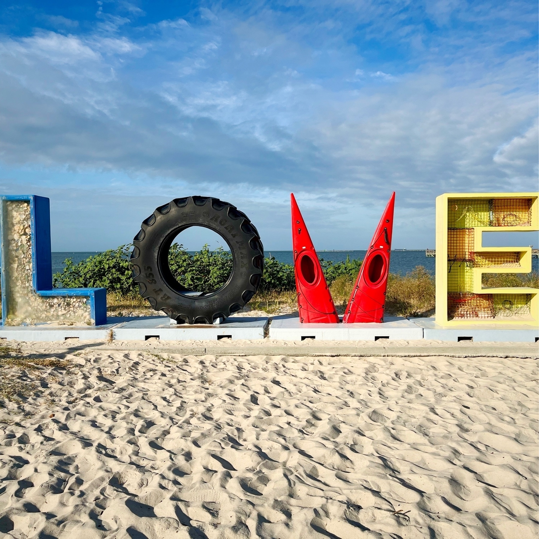 letters L, O, V, and E next to the ocean