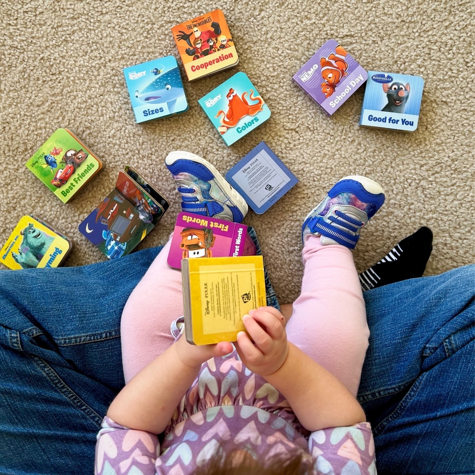 toddler and a pile of children's books